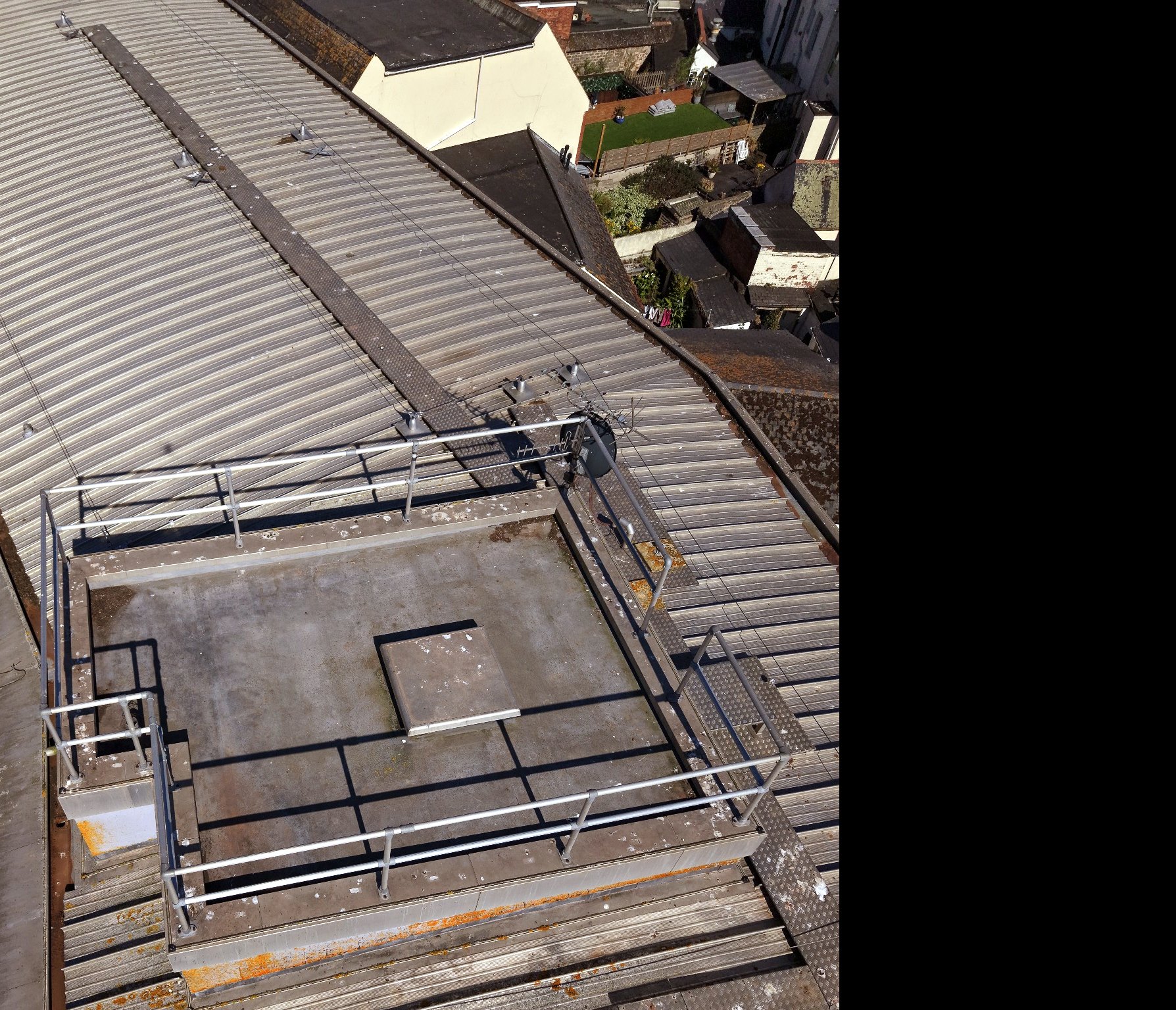 Real drone view of roof features, access zones and visible high-level condition context