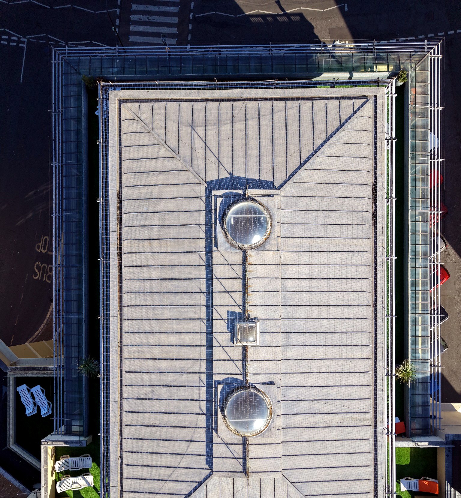 Real drone top-down view of a multi-occupancy roof and managed property access context